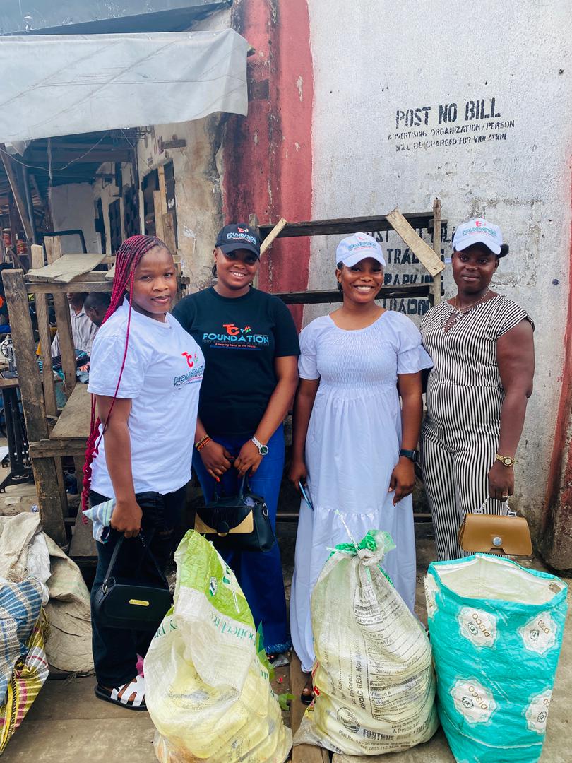 Volunteers deliver bags of staple food to traders and families at a market.