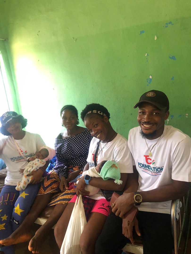 Volunteers with mothers and their newborn babies during a maternity ward visit.