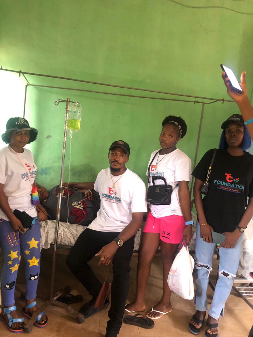 Visiting a patient receiving treatment during a hospital visit.